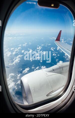 Window view from inside the aircraft during the flight over the ocean. Stock Photo
