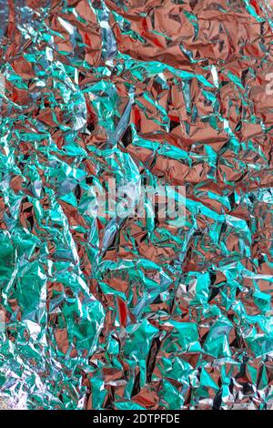 Chrome tint foil texture with crumpled structure effect. Fashion luxury background with turquoise colors and rose gold effect Stock Photo