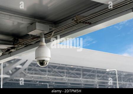 Closeup CCTV cameras on the roof with blue sky background. Stock Photo