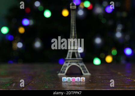 A shot of plastic cubes with the word PARIS with the Eiffel tower in the background Stock Photo