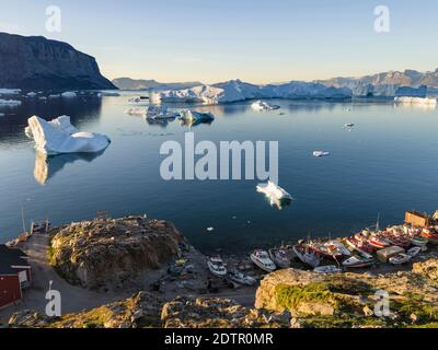 View of fjord full of icebergs towards Nuussuaq (Nugssuaq) peninsula during midnight sun. The town Uummannaq in the north of West Greenland, located o Stock Photo