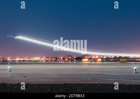 Night lights, tracks of lights in the movement of aircraft on long exposure. Stock Photo