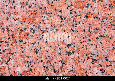 Texture of natural granite, red, scarlet black speckle Stock Photo
