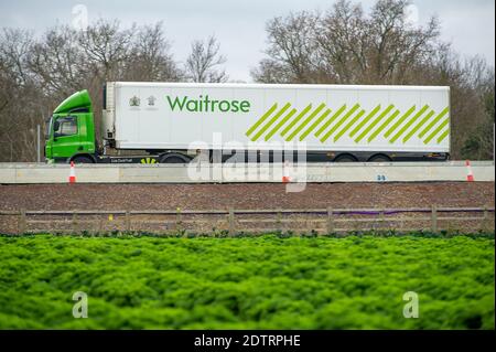Dorney, UK. 22nd December, 2020. A Waitrose Supermarket HGV on the M4 today. Following the new Covid-19 variant in the South East of England, France have closed their channel ports to UK freight. Despite, this it was business as usual today as there were plenty of freight shipments still being transported on the M4. The action by Emmanuel Macron the President of France may lead to some temporary shortages of imported citrus fruit and vegetables from the EU, however, the French action appears to only be strengthening the campaign to buy British. Credit: Maureen McLean/Alamy Live News Stock Photo