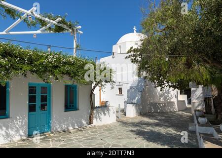 Folegandros Island, Chora, Greece - 23 September 2020: A narrow side street in Chora, old town. Saint Catherine Church. Stock Photo