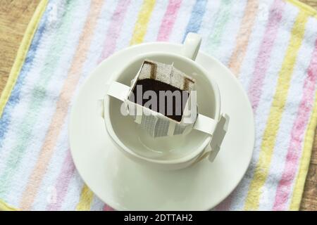coffee drip mixed by hot water pouring from ceramic jar on cup Stock Photo