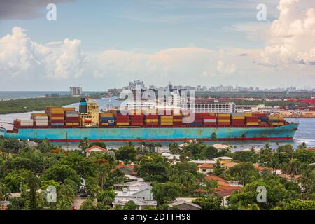 A cargo ship passes through the rivers of Ft. Lauderdale, Florida, USA. Stock Photo