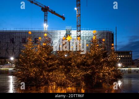 decorated Christmas trees on Roncalliplatz in front of the Dom Hotel under renovation during the Corona Pandemic, Cologne, Germany. There is usually a Stock Photo