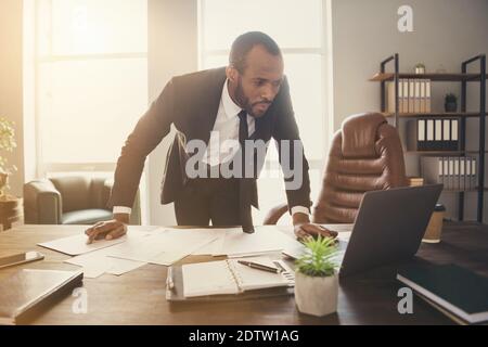 Portrait of his he nice attractive classy trendy elegant focused busy skilled guy executive director economist analyzing project start-up growth Stock Photo