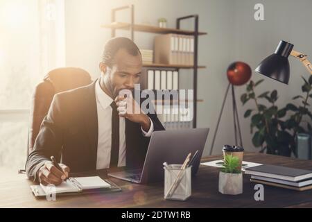 Portrait of his he nice attractive chic skilled smart clever focused guy marketer director writing plan strategy agenda appointment meeting week month Stock Photo