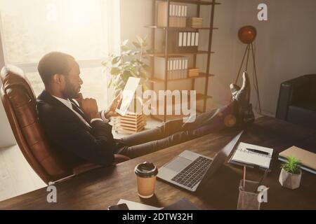 Profile side view portrait of his he nice attractive classy focused guy economist accountant financier sitting in chair reading news research data Stock Photo