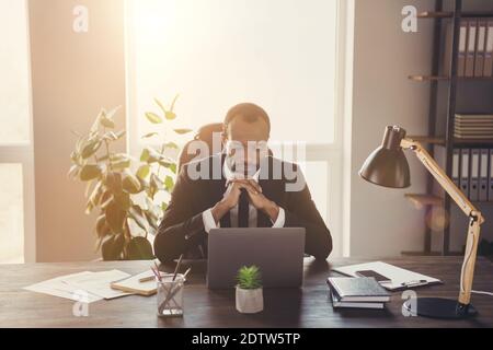 Portrait of focused concentrated afro american man marketer manager sit desk work laptop decide start up solution feel thoughtful wear tux tuxedo suit Stock Photo