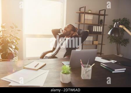 Portrait of his he nice attractive dreamy classy stylish cheerful cheery guy economist banker agent broker sitting in chair enjoying employment at Stock Photo