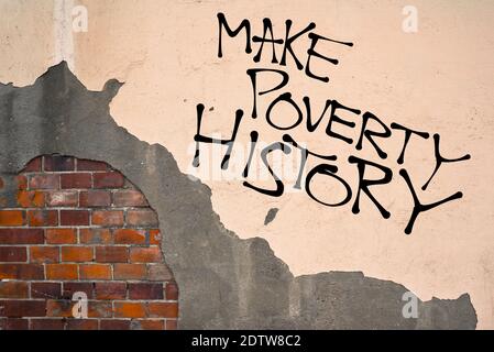 Handwritten graffiti Make Poverty History sprayed on the wall, anarchist aesthetics. Appeal to solve situation of poverty, economy and suffering in po Stock Photo