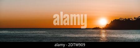 Beautiful panoramic sunset over the ocean on a clear and calm day in Turkey Stock Photo