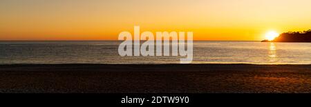 Beautiful panoramic sunset over the ocean on a clear and calm day in Turkey Stock Photo