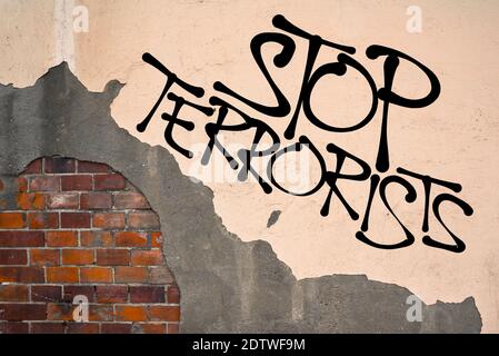 Stop Terrorists - Handwritten graffiti sprayed on the wall, anarchist aesthetics - Appeal to establish security and prevention to prevent terrorism an Stock Photo