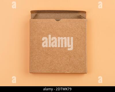 Open slim textured cardboard box close up. Isolated on beige, clipping path included Stock Photo