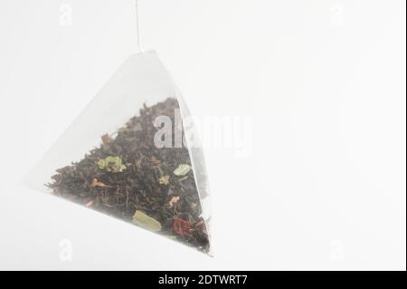 Triangular shape tea bag isolated on white studio background Stock Photo