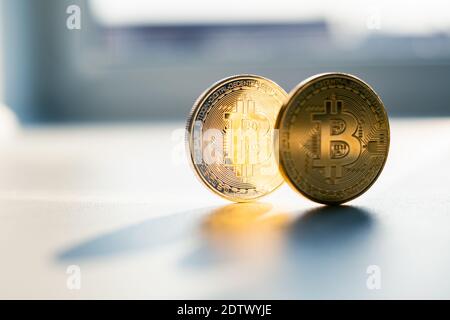 Golden bitcoin coins on white table closeup. E-business cryptocurrency concept Stock Photo