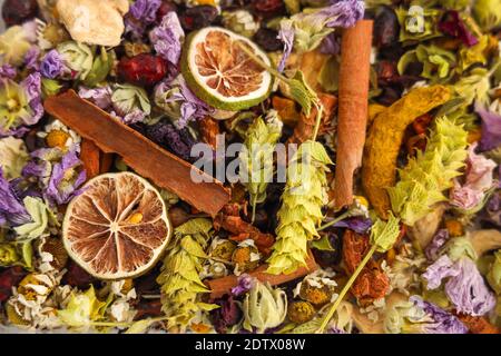 Dried winter herbal tea varieties with dried rosehip and roses, slices of lemon, marigold petals, sage, ginger, rosehip, cinnamon, Mallow blossom,.