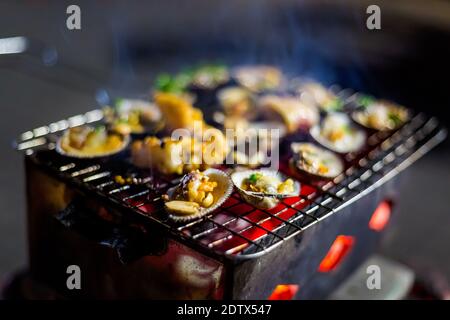 Delicious grilled seafood by the sea in Tuy Hoa. Traditional vietnamese cuisine served in harbour restaurant Phu Yen province, Vietnam. Stock Photo