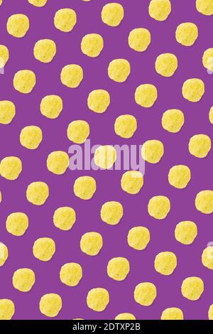 background made from Potato chips on purple background flat lay. potato snack chips isolated Fast food banner. Stock Photo