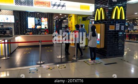RAwang, Selangor, Malaysia, 23rd December 2020 - McDonald fast food restaurant shop counter with people wear mask during Covid 19 pandemic Stock Photo