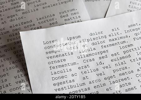 lorem ipsum dolor sit amet concept. selective focus photo of paper sheets with publishing and graphic design placeholder text on them. Stock Photo