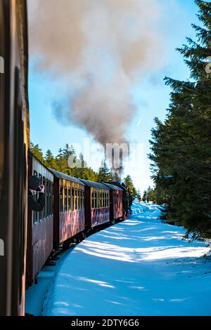 Harz national park Germany, Steam train on the way to Brocken through the winter landscape, Famous steam train through the winter mountain. Brocken, Harz National Park Mountains in Germany Europe Stock Photo