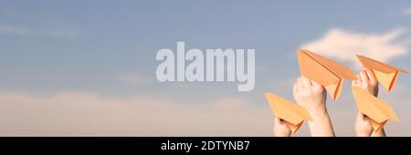 The hands throw upwards messages in the manner of paper airplanes. Stock Photo