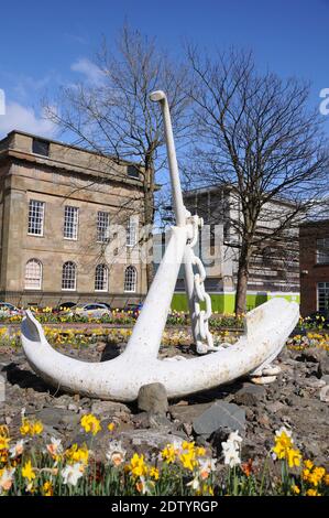 A large white ships anchor on display in Greenock, Scotland denoting the area's long historic connection with the shipping industry. Stock Photo