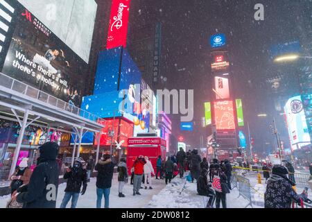 Tourists and visitors enjoy during the First winter storm hits in Times Square. Stock Photo