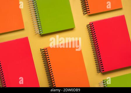 Geometric pattern made with colorful spiral notepads on a yellow background Stock Photo