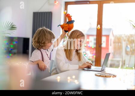 Mother trying to work from home with her kids as a company Stock Photo