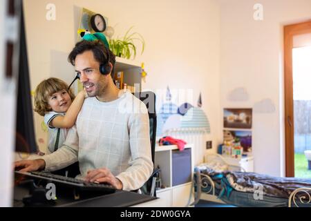 Father trying to work from home with his kids Stock Photo