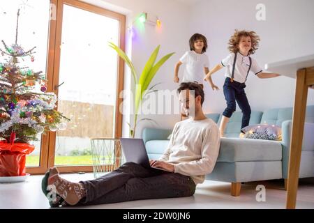 Father trying to work from home with his kids Stock Photo