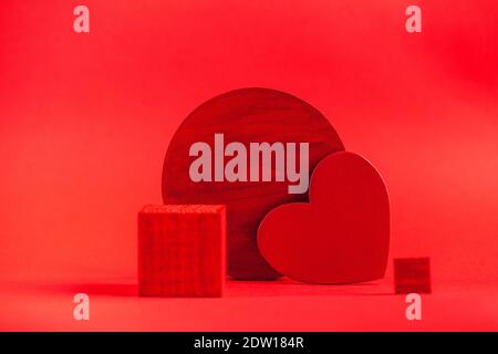 Empty podium for your products with a heart on a red background. Concept of valentine's day, love. Copy space Stock Photo