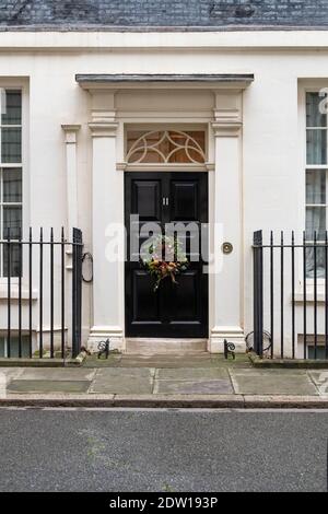 Downing Street, London UK at Christmas 11 Downing street door with Christmas wreath Stock Photo