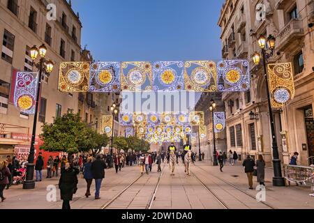 Seville, Spain - December 21,2020: Unidentified People walking around Seville Cathedral of Saint Mary of the See (Seville Cathedral) at christmas time Stock Photo