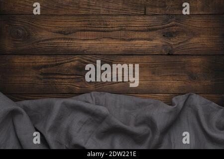 Gray linen cloth on wooden background. Brown wooden tabletop. Copy space for text. Stock Photo