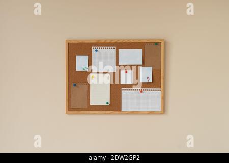 cork board with blank papers wooden frame. notes. colourful pin and paperclips . reminder. pin board. isolated. new year's resolution, goals. to do li Stock Photo