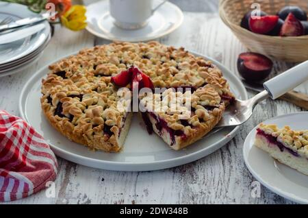 Delicious homemade tart with plums on a wooden background Stock Photo