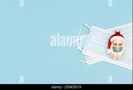 Christmas ornament Santa Claus with face mask. Corona virus lockdown concept Stock Photo