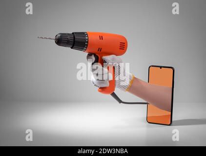 Hand holding a corded drill from out of a phone screen Stock Photo