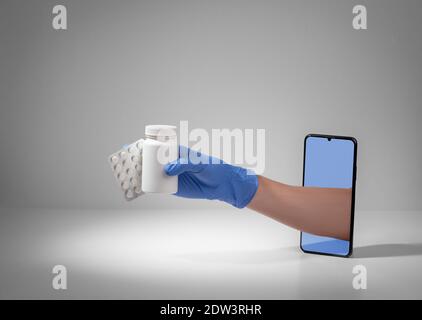 Hand in a latex glove giving pills from out of a phone screen Stock Photo