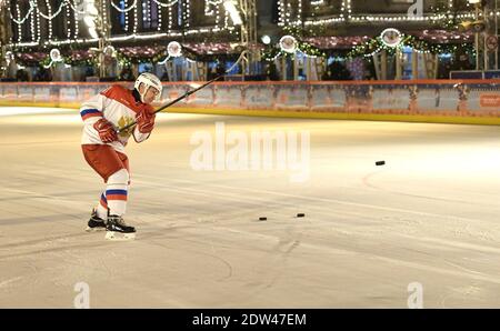 Moscow, Russia. 22nd Dec, 2020. Russian President Vladimir Putin, plays ice hockey with nine-year-old Dmitry Ashchepkov on the GUM ice rink at Red Square December 21, 2020 in Moscow, Russia. Ashchepkov had the opportunity as part of the annual Christmas Tree of Wishes campaign. Credit: Planetpix/Alamy Live News Stock Photo