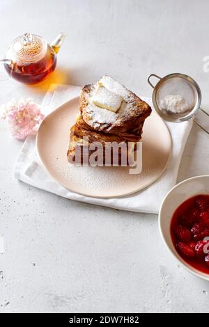 French toasts for breakfast with butter and powdered sugar Stock Photo