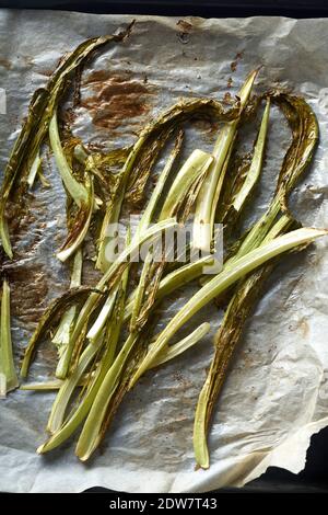 Roasted cauliflower greens on baking paper Stock Photo