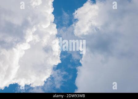 blue sky in gap between heavy cumulus clouds, clearing up of weather Stock Photo